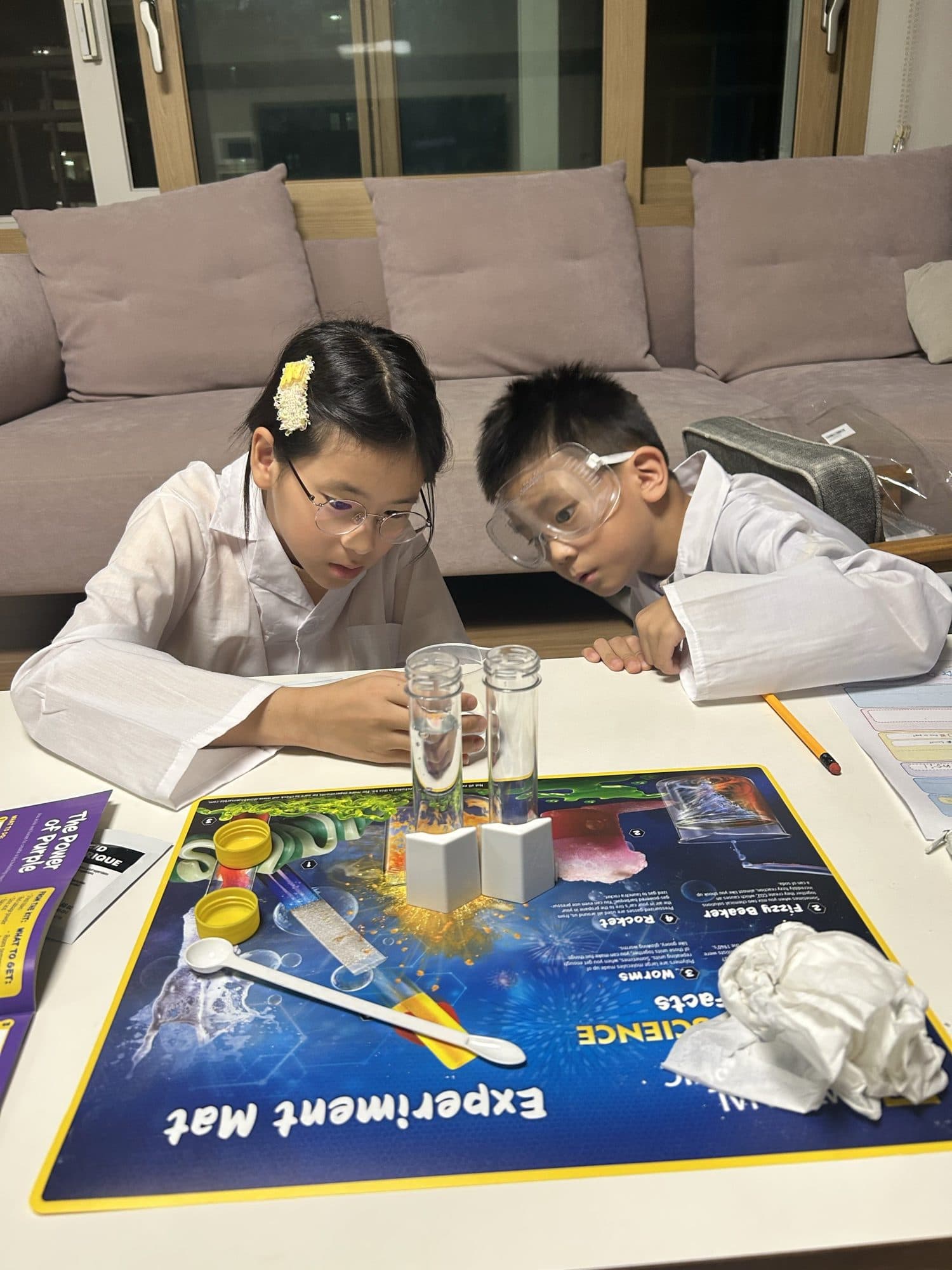 Me and my lab partner looking closely at two test tubes